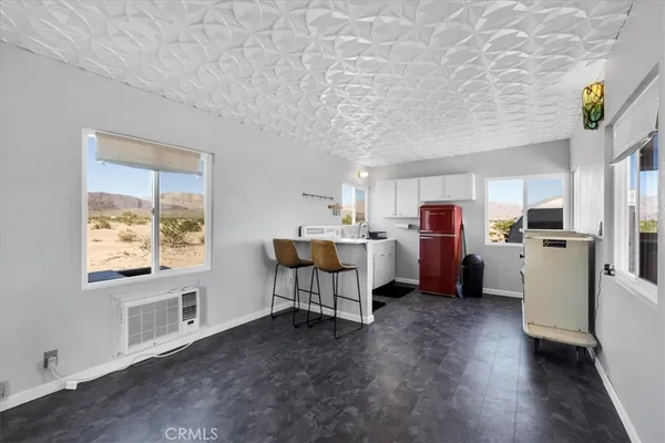 a kitchen with refrigerator cabinets and wooden floor