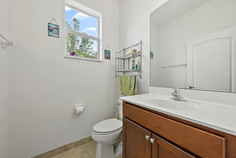 a bathroom with a sink mirror vanity and toilet