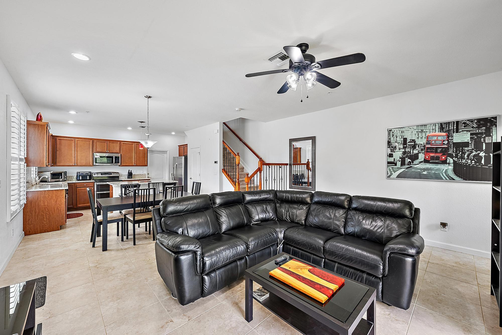 9677 Southwest Purple Martin Way Stuart, FL 34997 - Photo 9 of 29 a living room with furniture kitchen view and a wooden floor