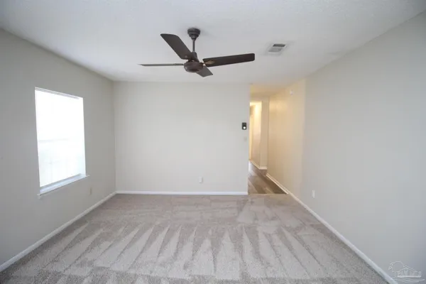 a view of a big room with wooden floor closet and windows