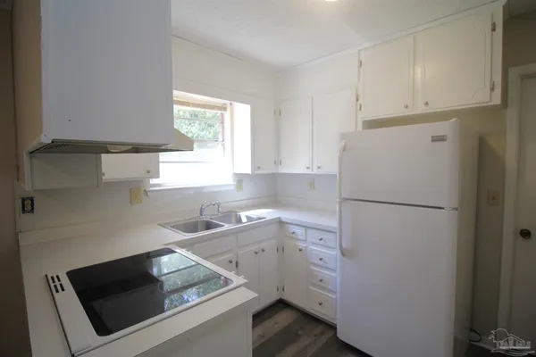 a utility room with cabinets washer and dryer