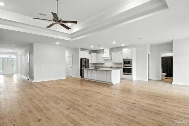 a kitchen with stainless steel appliances a refrigerator and a stove top oven