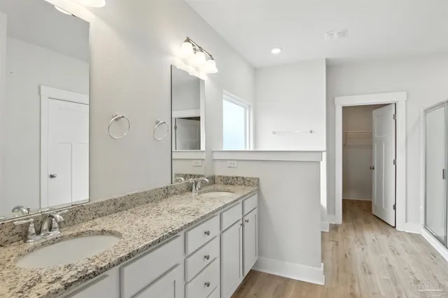 a white bath tub sitting next to a shower