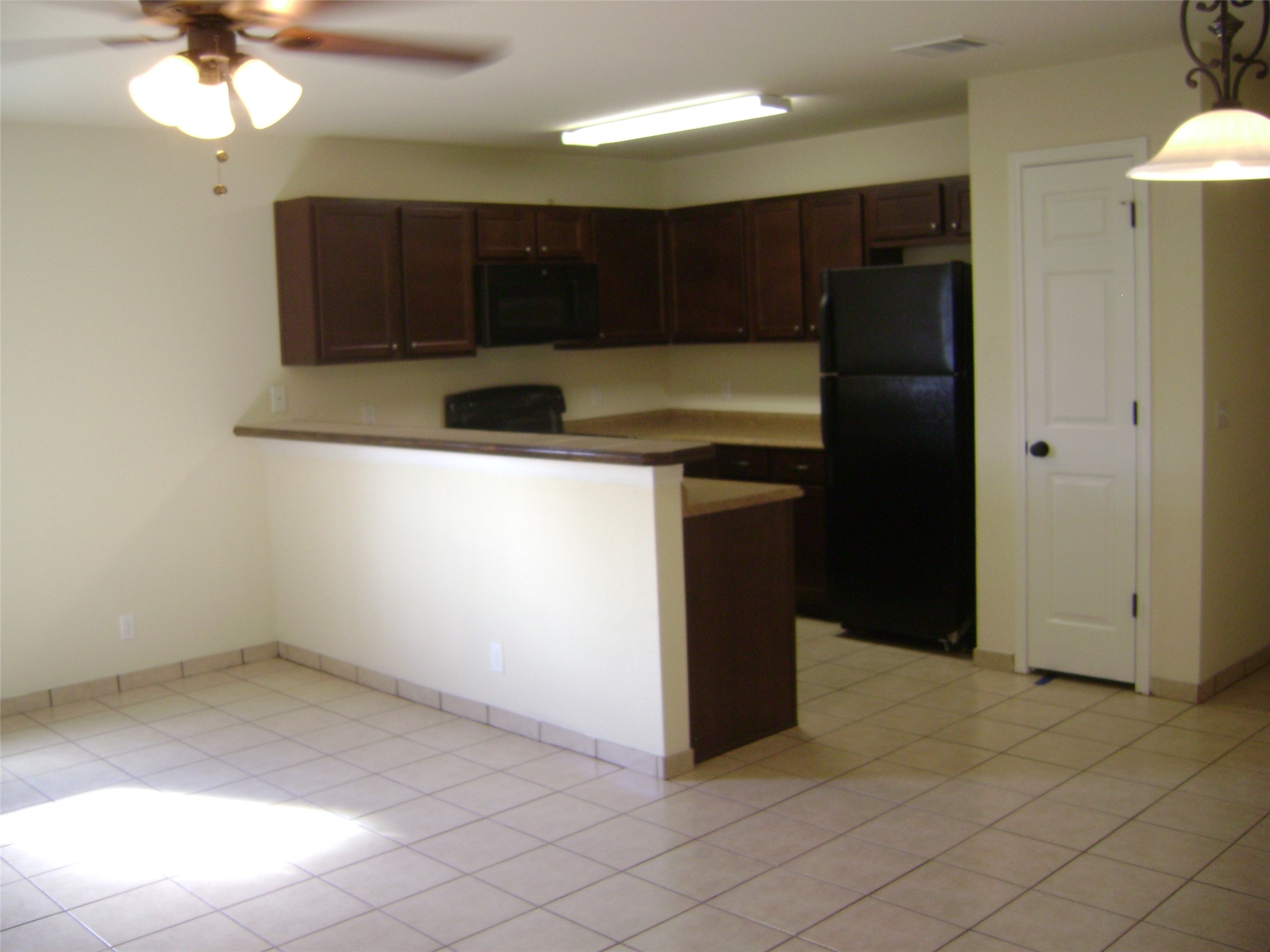 2507 Oak Lane, Unit A Georgetown, TX 78628 - Photo 3 of 11 An inviting kitchen with rich cabinetry and ample counter space for culinary endeavors.