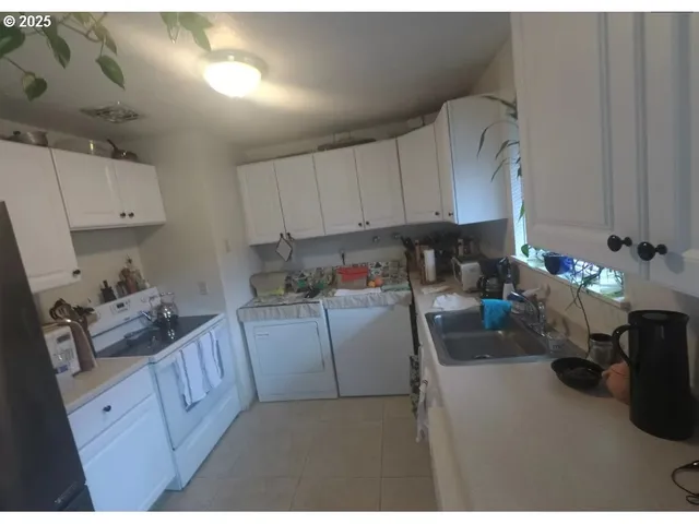 a kitchen with cabinets a stove and a wooden floors
