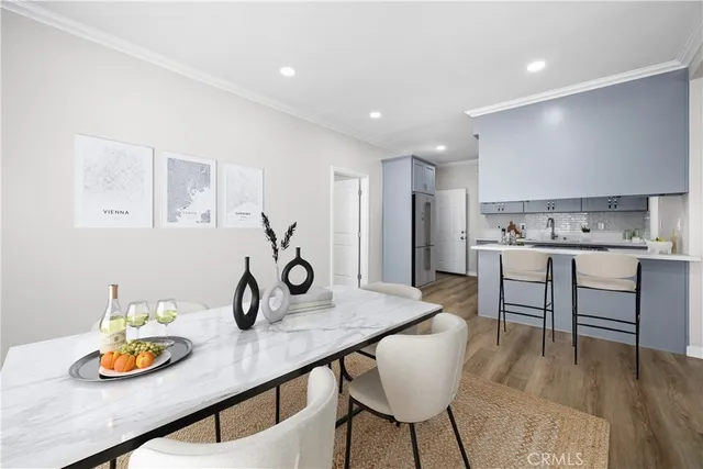 a kitchen with a table chairs and a wooden floor