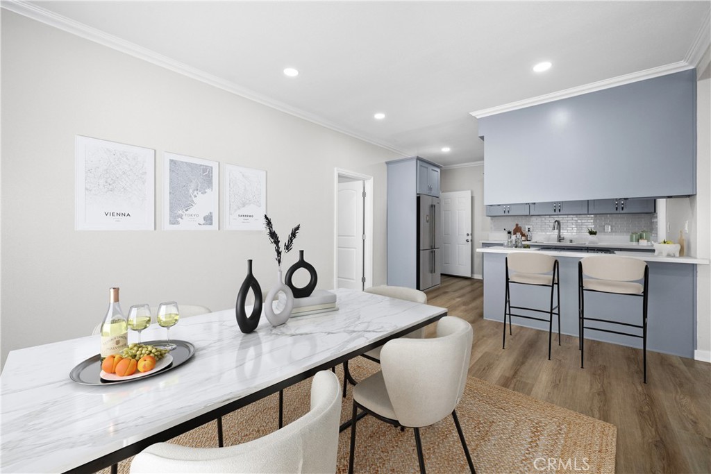 a kitchen with a table chairs and a wooden floor