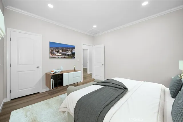 a bedroom with a bed and a painting on the wall