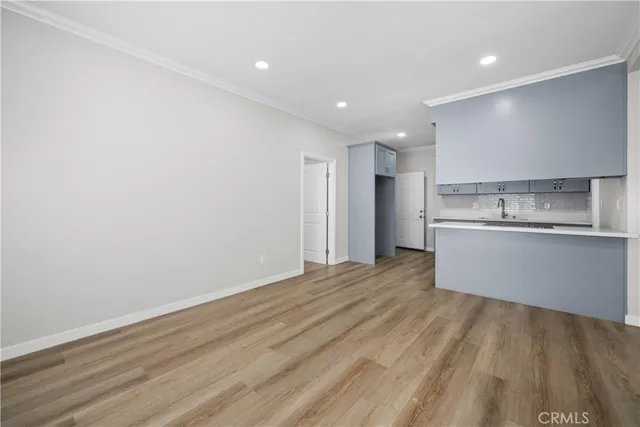 a view of a kitchen with a sink and a refrigerator