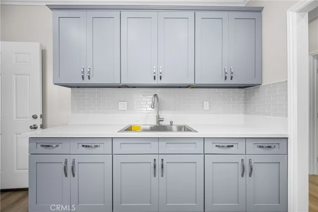a kitchen with white cabinets and a sink