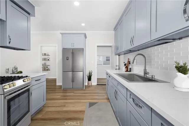 a kitchen with a sink stove and refrigerator