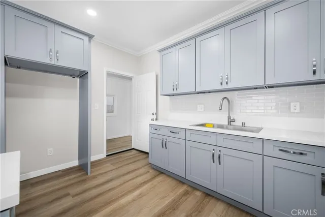 a kitchen with sink and cabinets