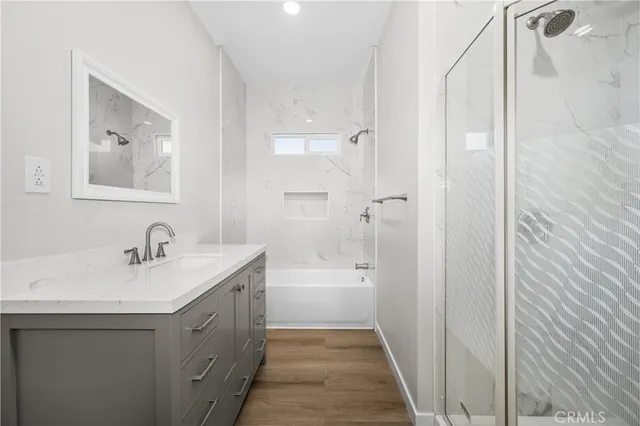 a bathroom with a tub sink and mirror