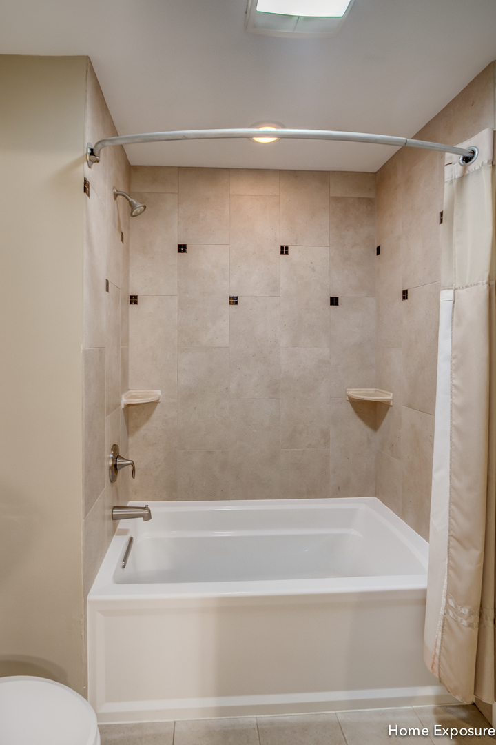 2433 Legacy Drive Aurora, IL 60502 - Photo 36 of 66 a bathroom with a bathtub and a shower