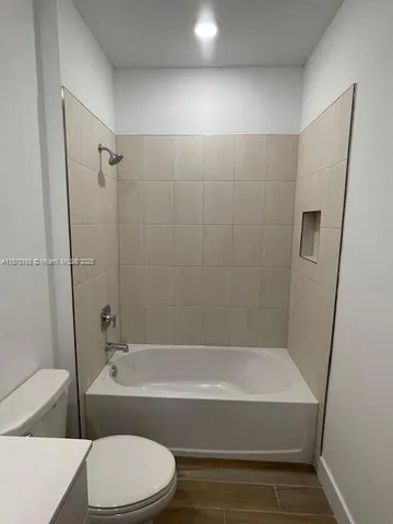a bathroom with a bathtub and toilet