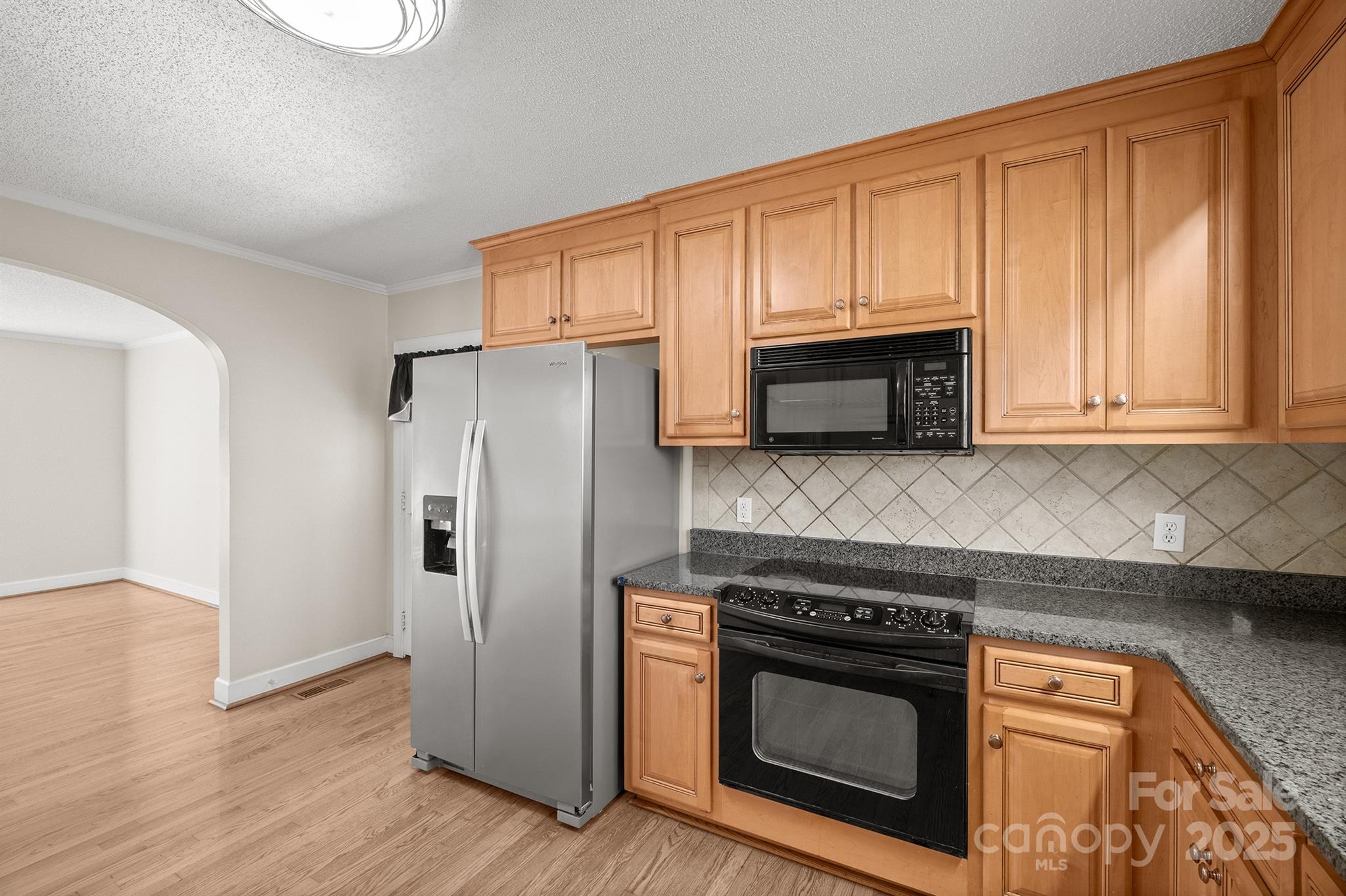 484 Stutts Road Mooresville, NC 28117 - Photo 12 of 28 a kitchen with granite countertop white cabinets and stainless steel appliances