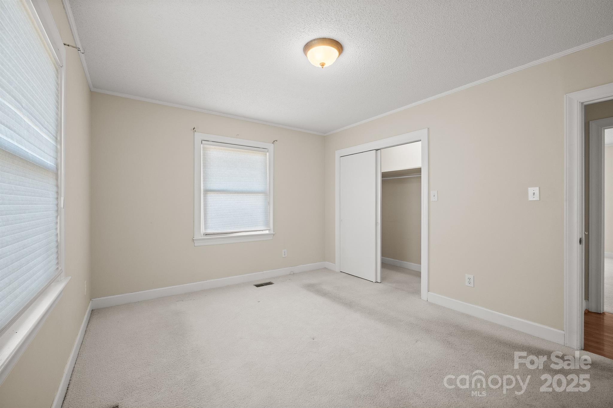 484 Stutts Road Mooresville, NC 28117 - Photo 24 of 28 an empty room with windows and closet