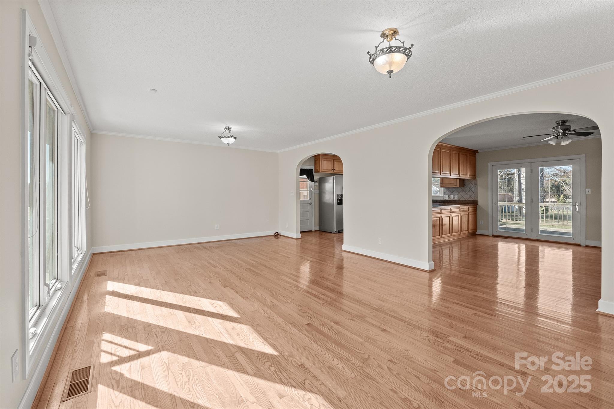 484 Stutts Road Mooresville, NC 28117 - Photo 4 of 28 a view of an empty room with window and wooden floor