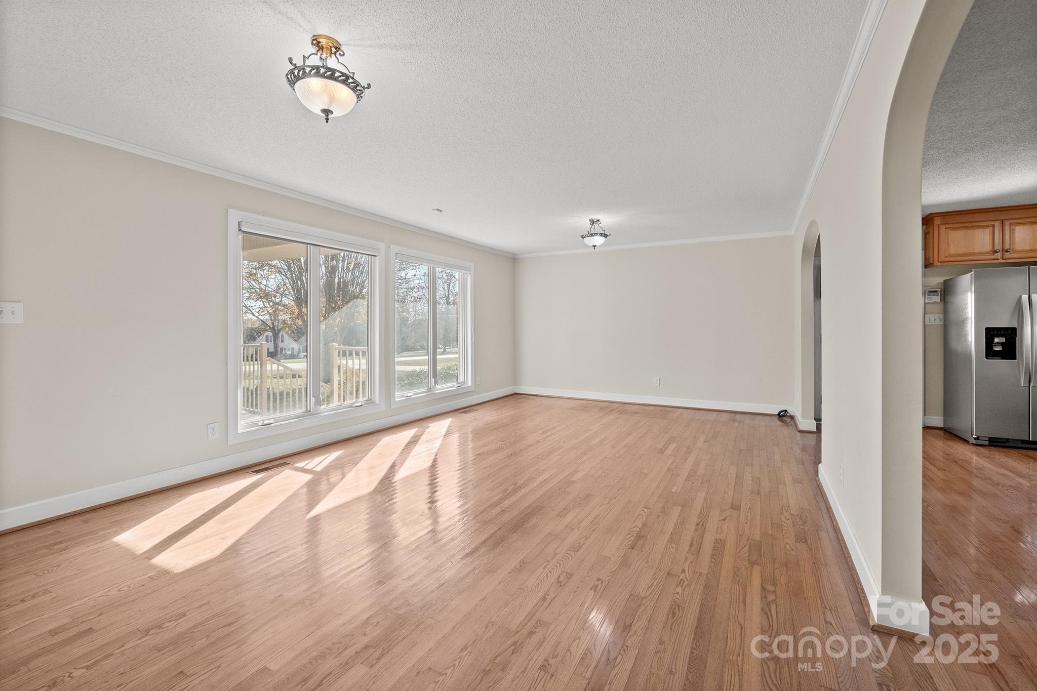 484 Stutts Road Mooresville, NC 28117 - Photo 5 of 28 wooden floor in an empty room with a window