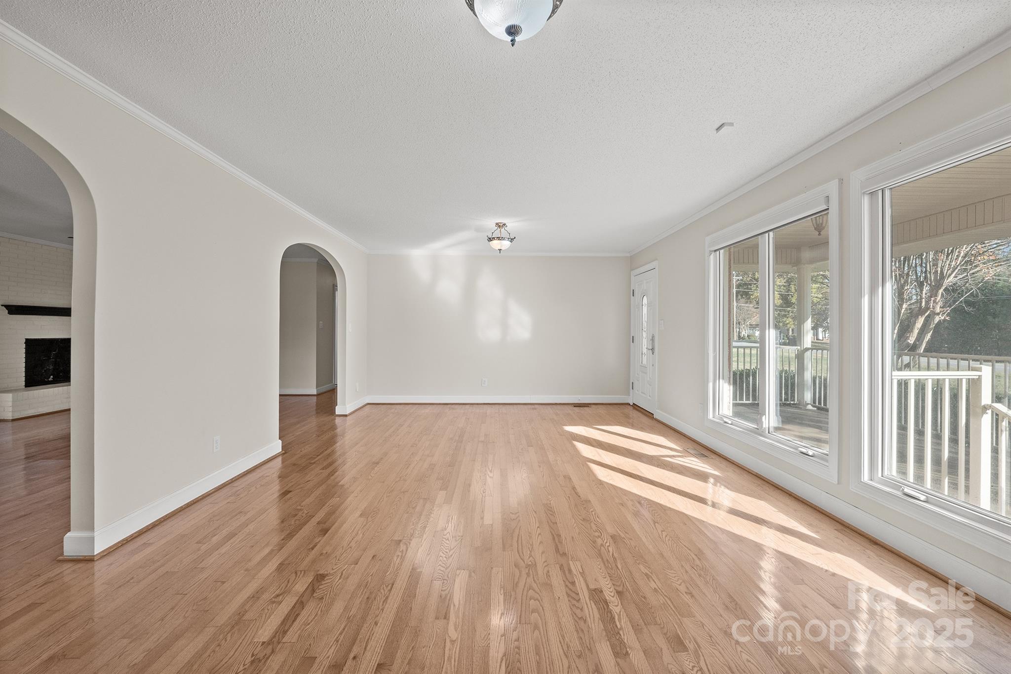 484 Stutts Road Mooresville, NC 28117 - Photo 6 of 28 a view of an empty room with wooden floor and a window