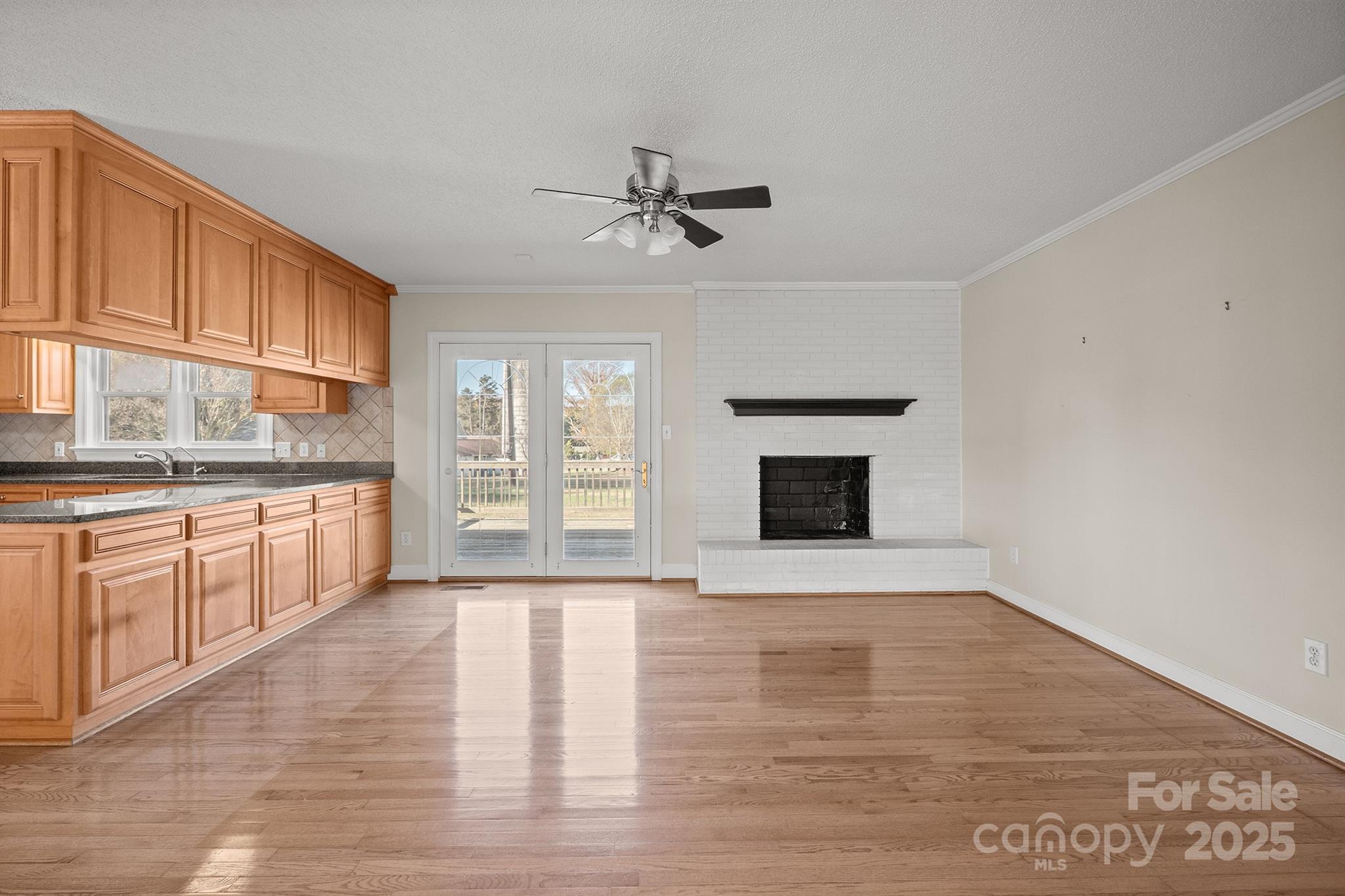 484 Stutts Road Mooresville, NC 28117 - Photo 8 of 28 a large kitchen with granite countertop a stove top oven a sink a counter space and cabinets