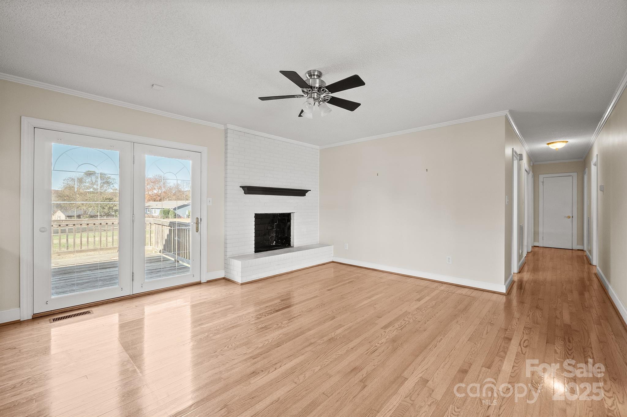 484 Stutts Road Mooresville, NC 28117 - Photo 9 of 28 a view of an empty room with a window and wooden floor