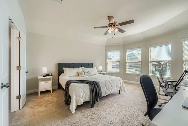 a bed room with a bed and a chair