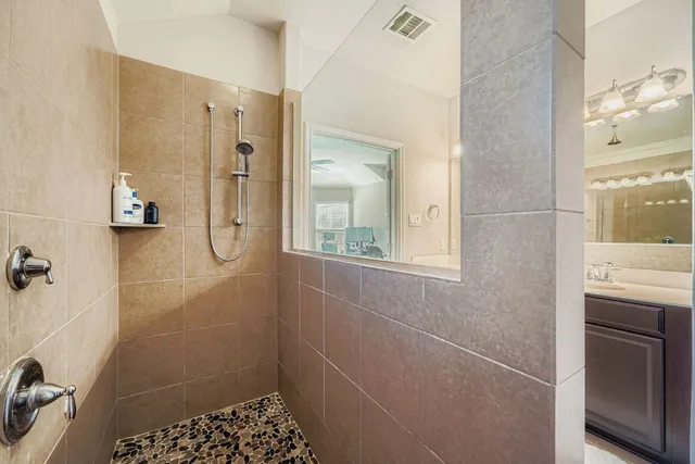 a bathroom with a shower and a sink
