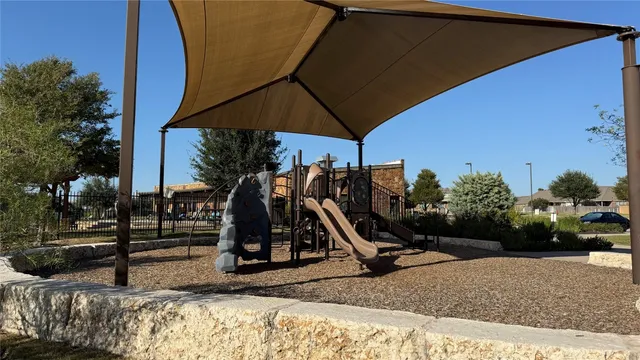 a view of a backyard with a table and chairs