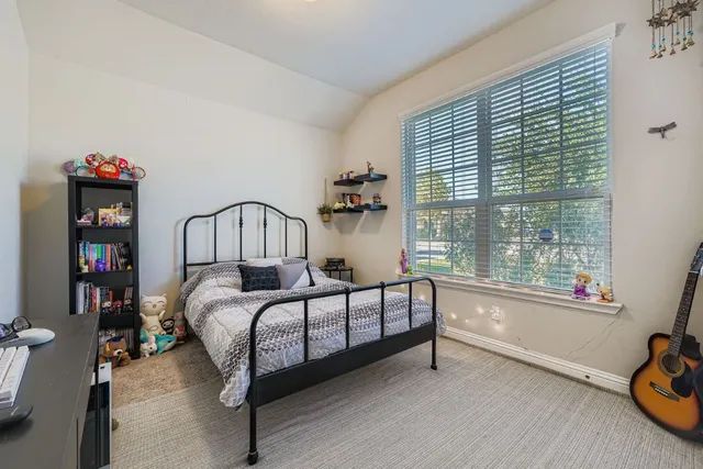 a bedroom with furniture and a window