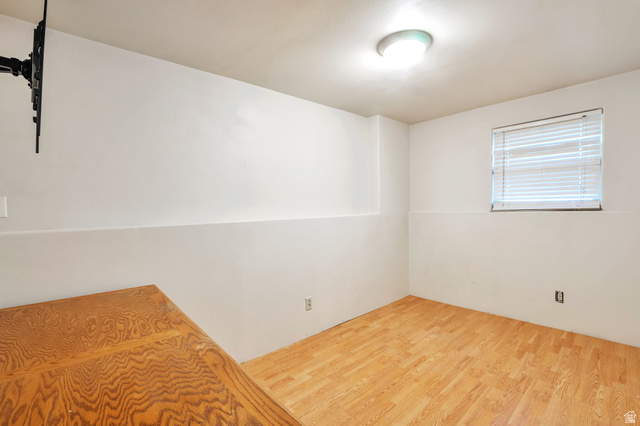 1057 North 700 West Clinton, UT 84015 - Photo 13 of 15 Unfurnished bedroom featuring wood finished floors