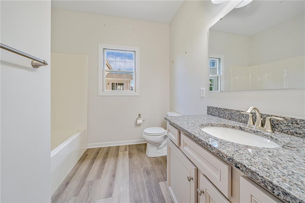 116 Brush Run Road Greensburg, PA 15601 - Photo 9 of 20 a bathroom with a granite countertop toilet a sink and a mirror