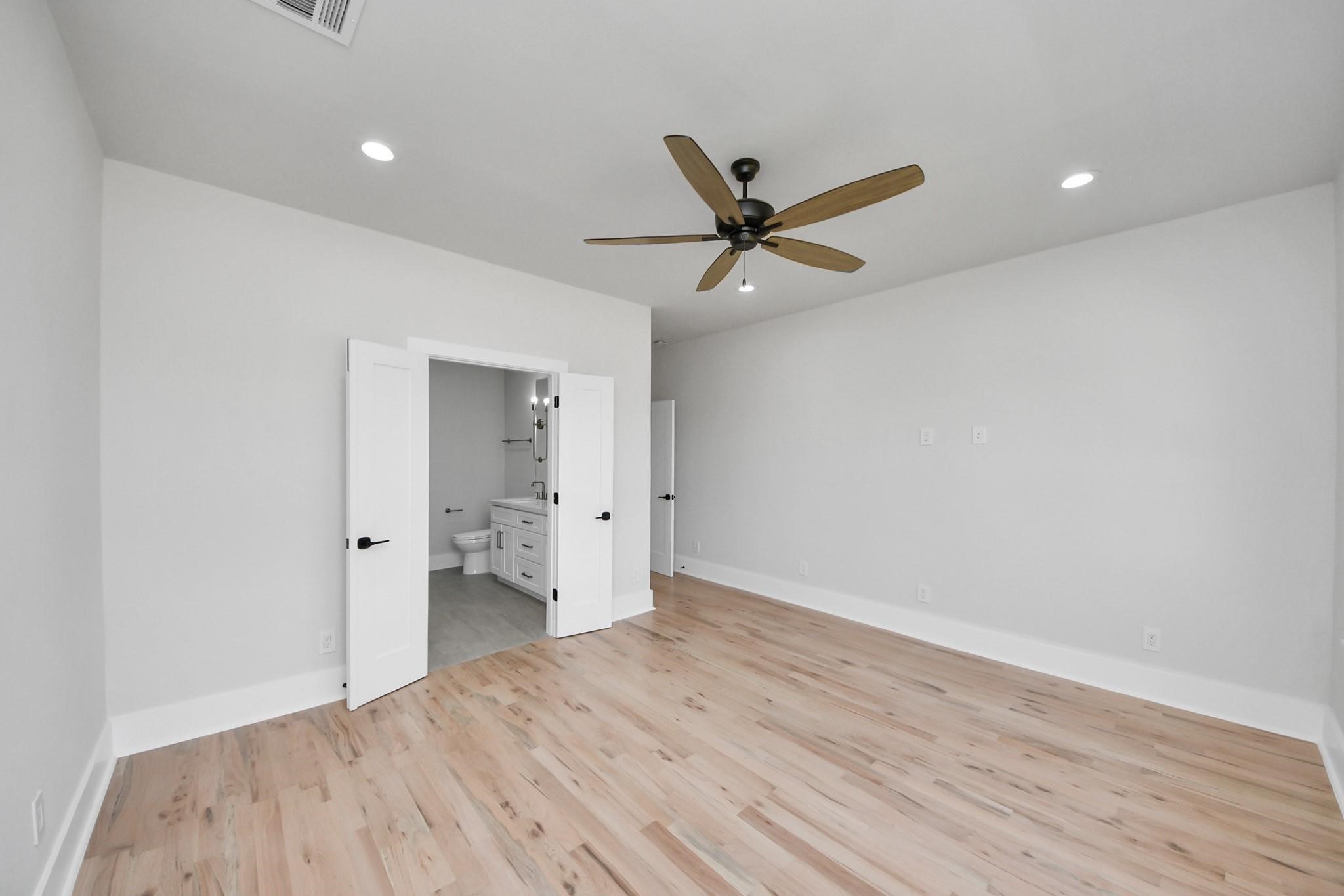 6320 Milwee Street, Unit B Houston, TX 77092 - Photo 19 of 30 a view of empty room with wooden floor