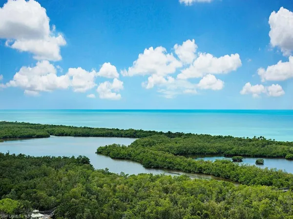 a view of a lake with houses in back