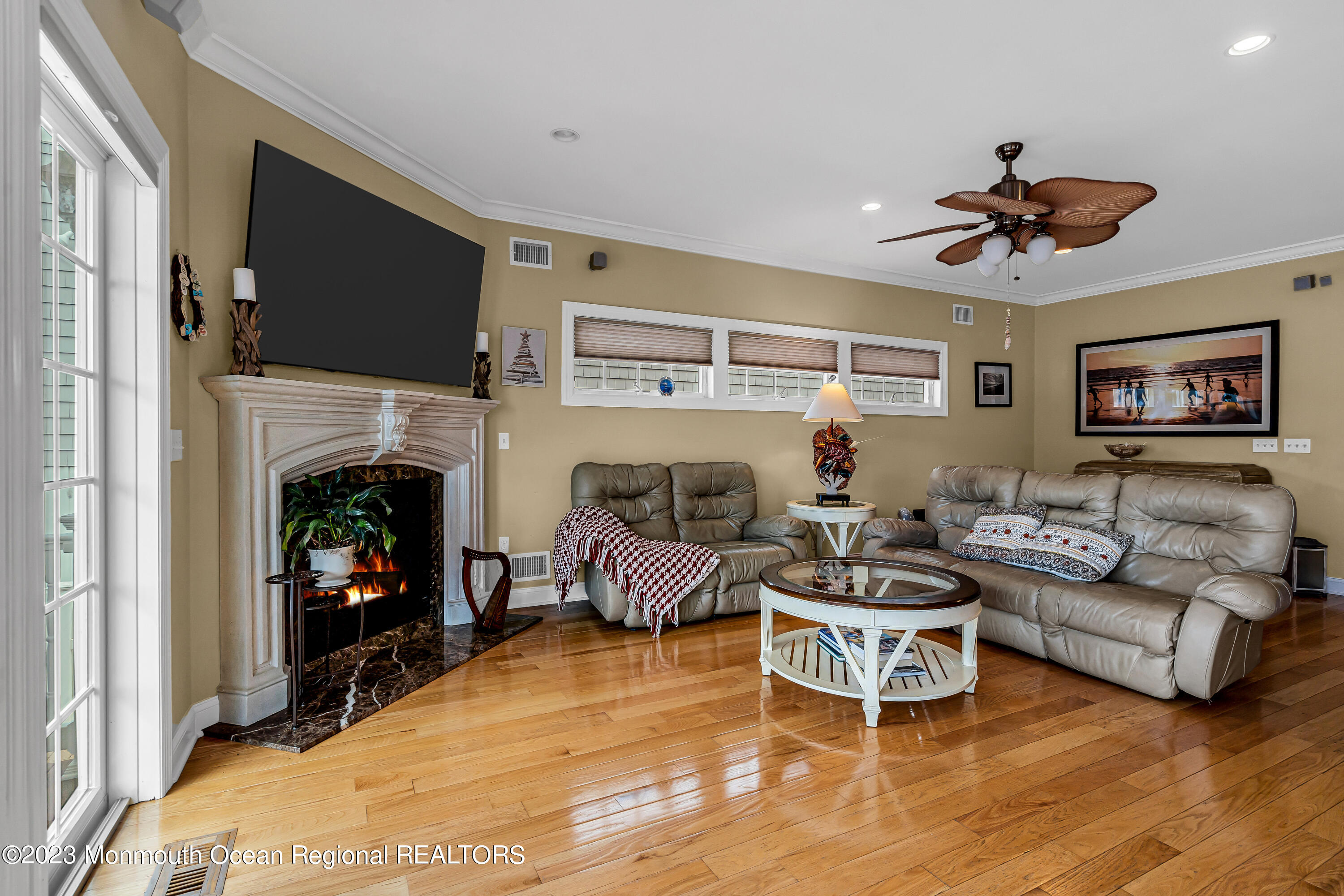 492 Brielle Road Manasquan, NJ 08736 - Photo 3 of 44 a living room with furniture a flat screen tv and a fireplace