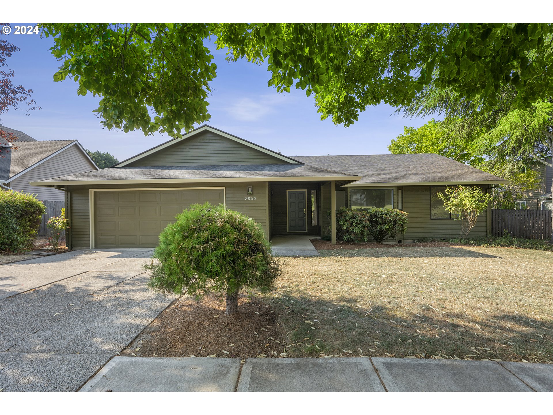 8860 Southwest Maverick Terrace Beaverton, OR 97008 - Photo 1 of 20 a front view of a house with a garden