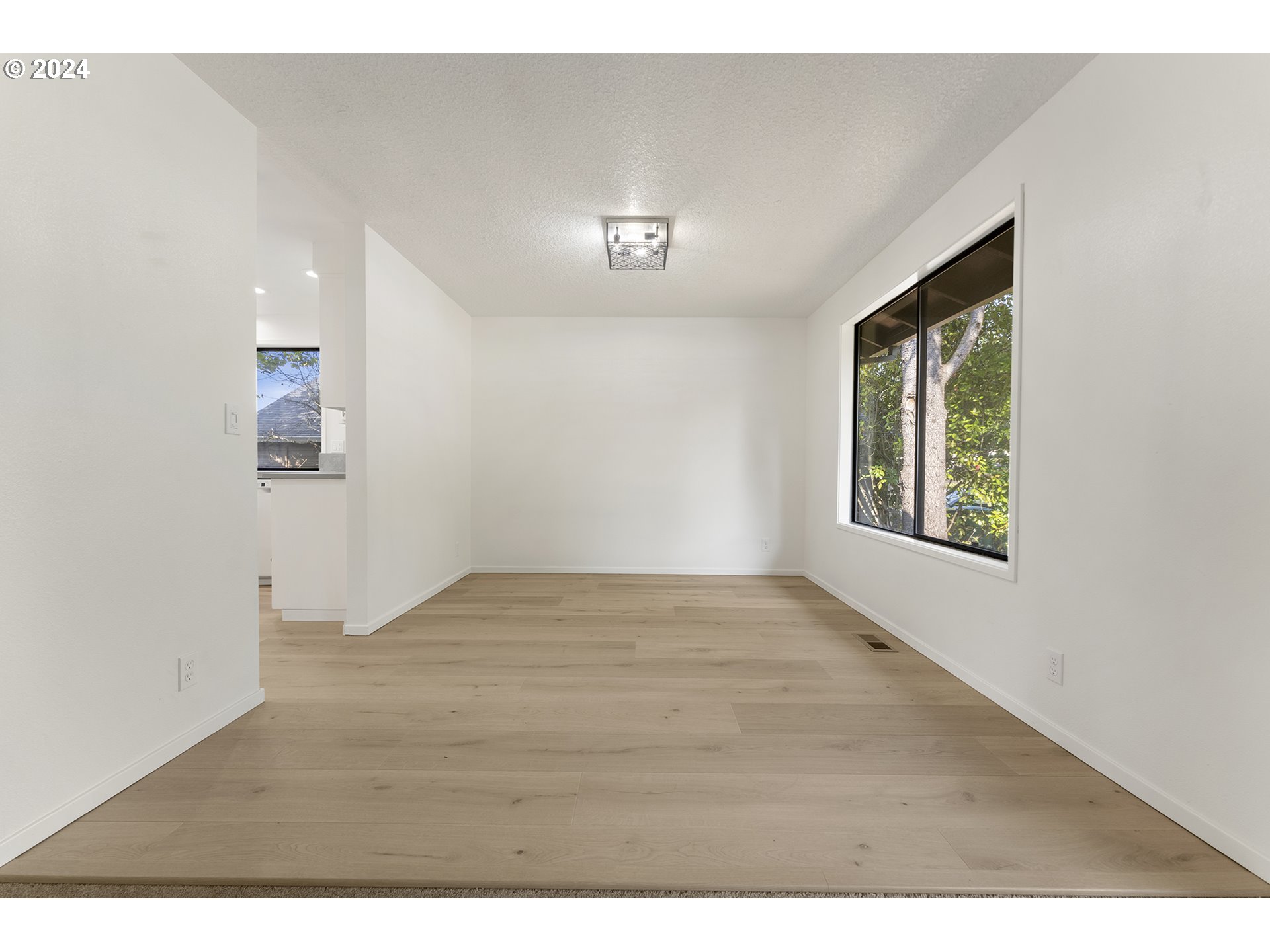8860 Southwest Maverick Terrace Beaverton, OR 97008 - Photo 11 of 20 a view of an empty room with wooden floor and a window