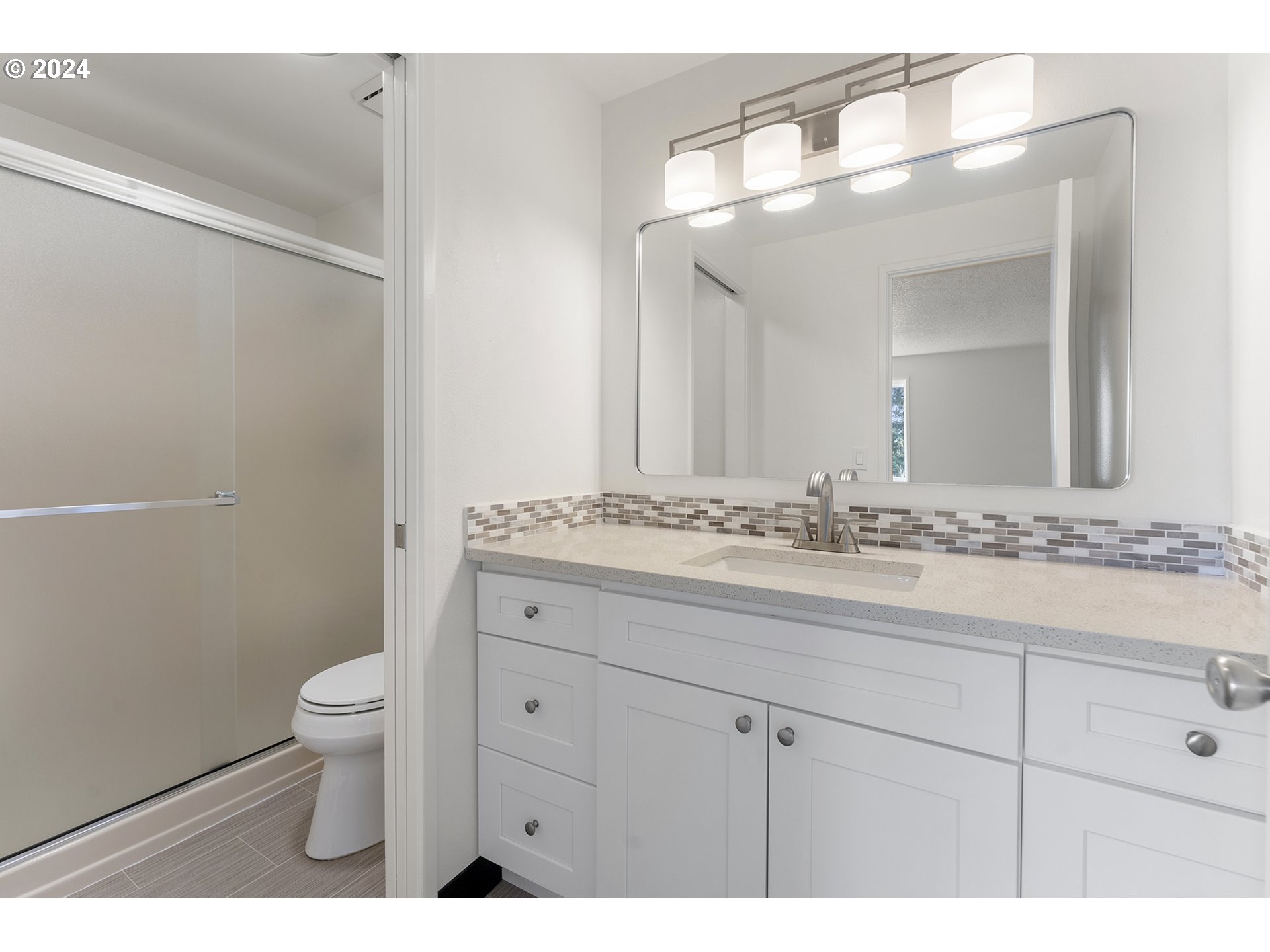 8860 Southwest Maverick Terrace Beaverton, OR 97008 - Photo 14 of 20 a bathroom with a granite countertop sink a toilet and a mirror