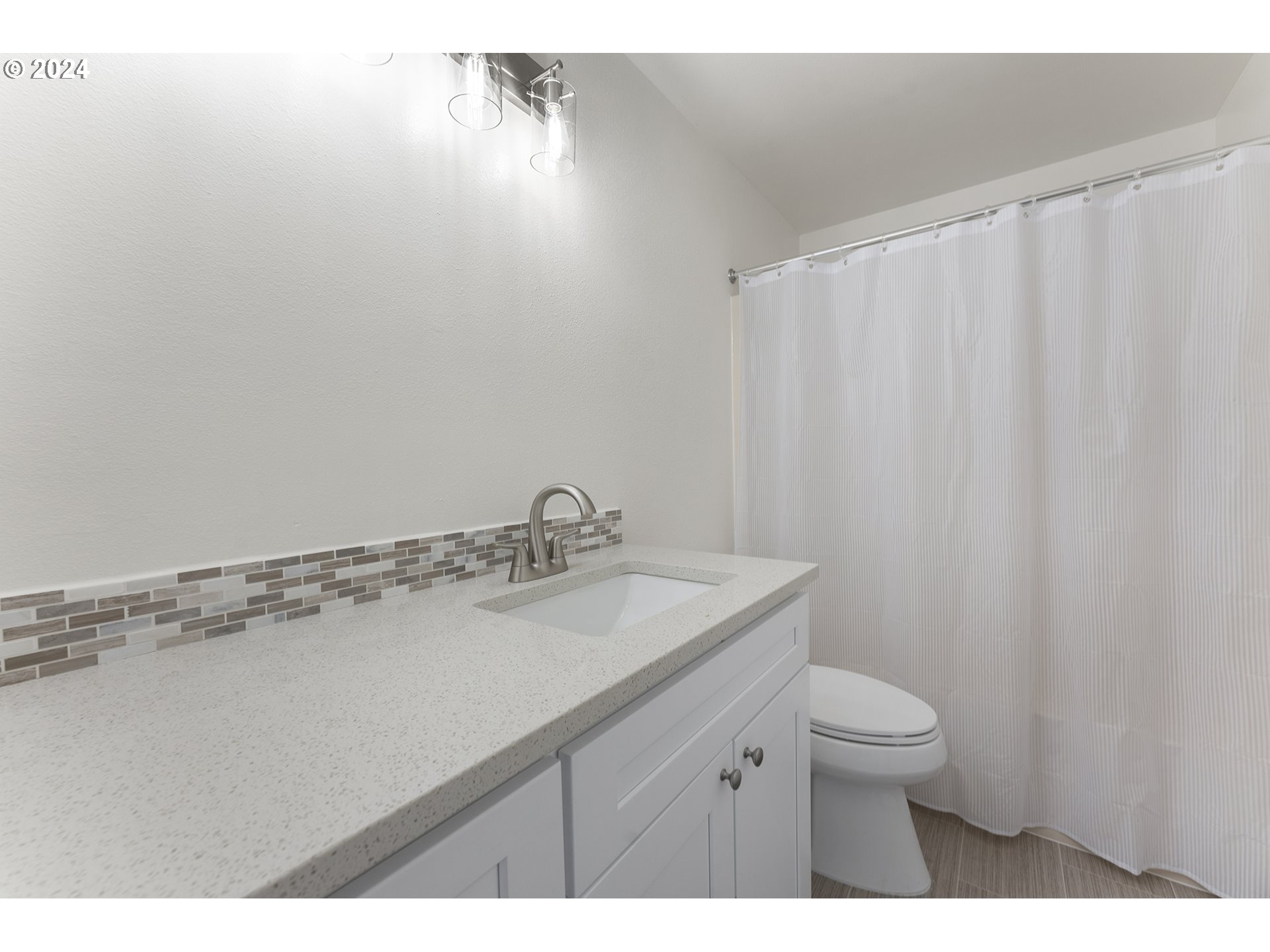 8860 Southwest Maverick Terrace Beaverton, OR 97008 - Photo 17 of 20 a bathroom with a sink toilet and vanity