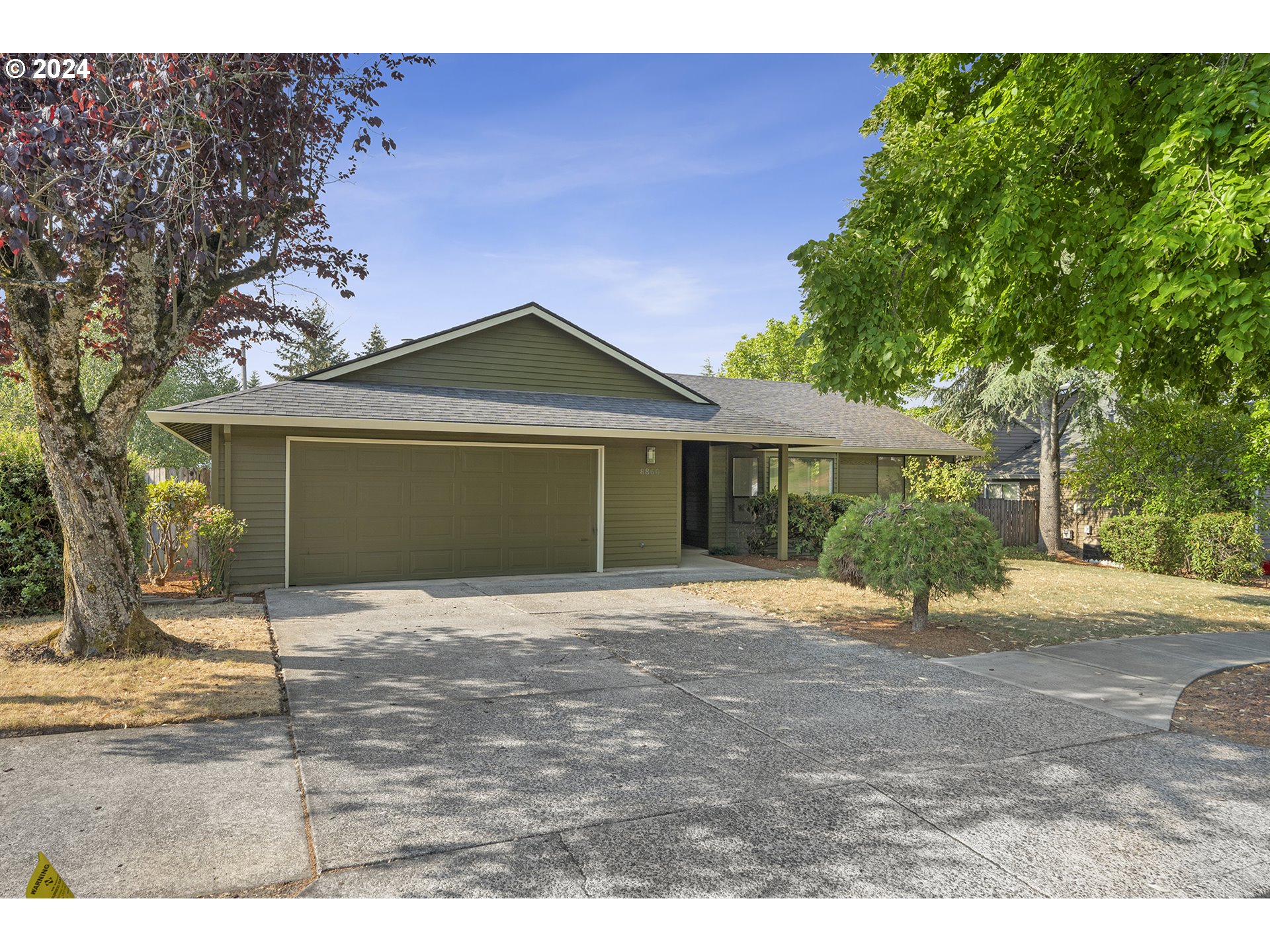 8860 Southwest Maverick Terrace Beaverton, OR 97008 - Photo 2 of 20 a front view of a house with a garden