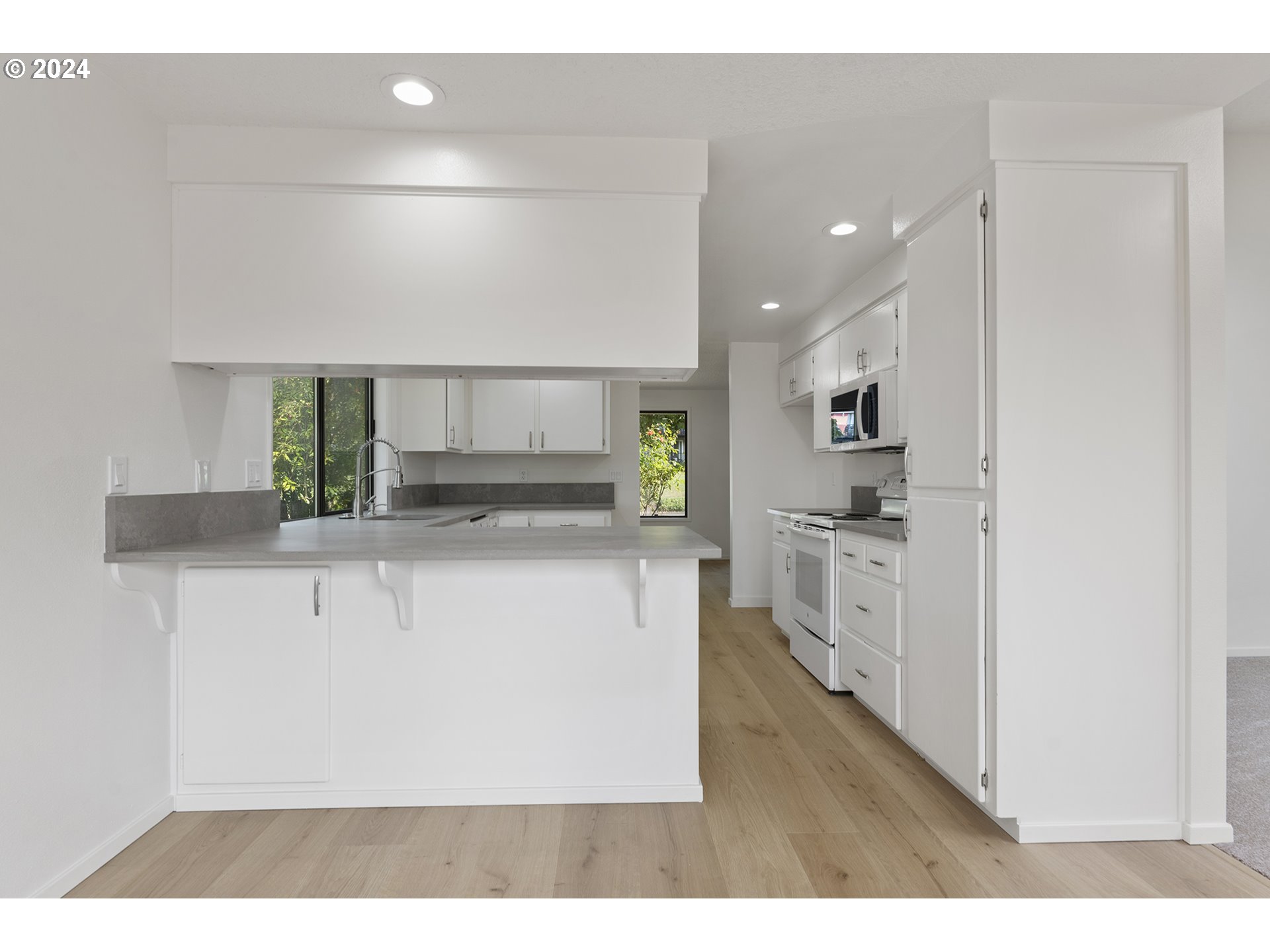 8860 Southwest Maverick Terrace Beaverton, OR 97008 - Photo 6 of 20 a kitchen with white cabinets and stainless steel appliances