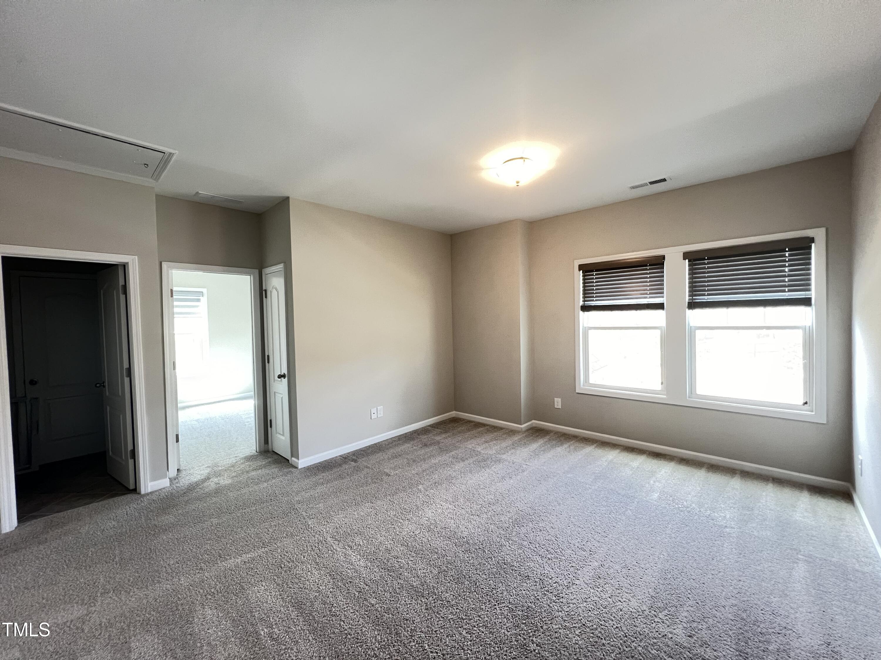 3385 Lovage Drive Apex, NC 27502 - Photo 18 of 19 an empty room with windows and closet