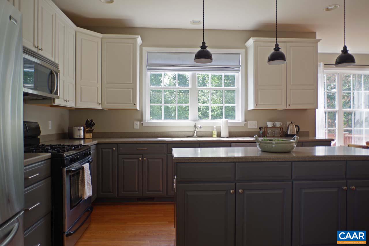 2059 Ridgetop Drive Charlottesville, VA 22903 - Photo 12 of 68 a kitchen with stainless steel appliances granite countertop a sink a stove and a wooden floors