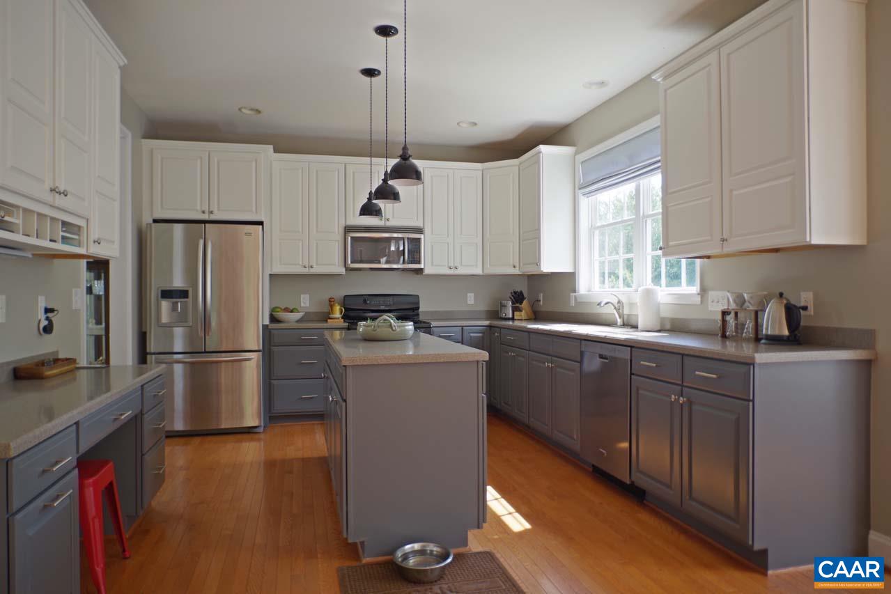 2059 Ridgetop Drive Charlottesville, VA 22903 - Photo 13 of 68 a kitchen with a refrigerator a sink dishwasher a stove and white cabinets with wooden floor