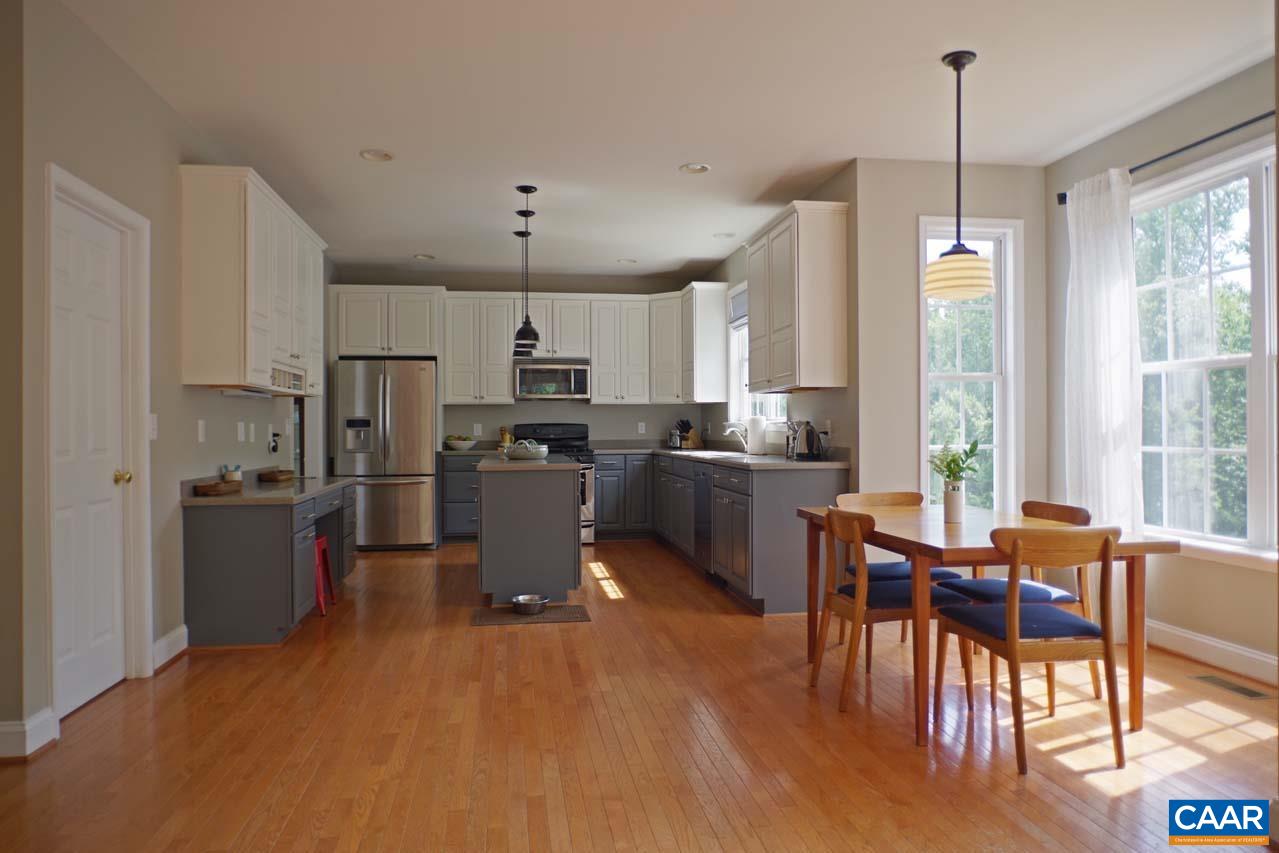 2059 Ridgetop Drive Charlottesville, VA 22903 - Photo 14 of 68 a kitchen with stainless steel appliances a dining table chairs stove refrigerator and cabinets