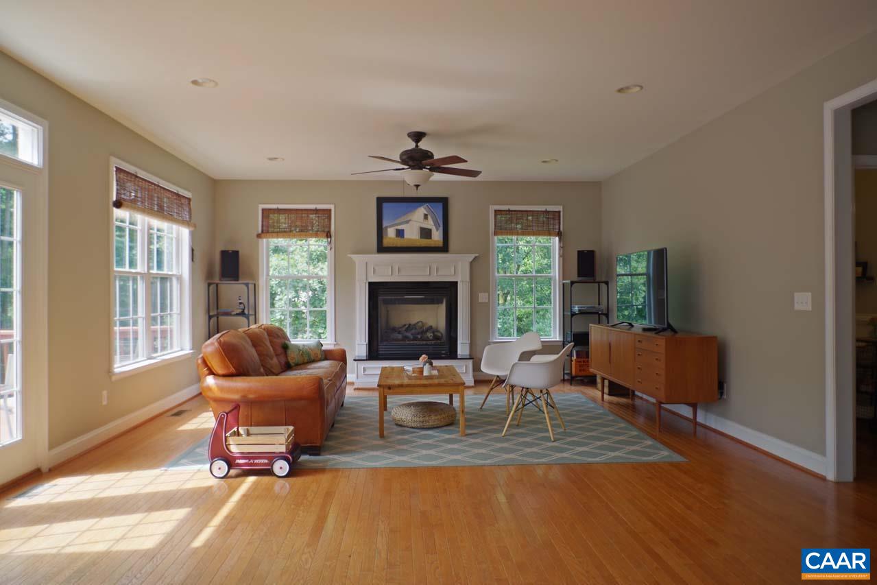 2059 Ridgetop Drive Charlottesville, VA 22903 - Photo 20 of 68 a living room with furniture a window and a fireplace