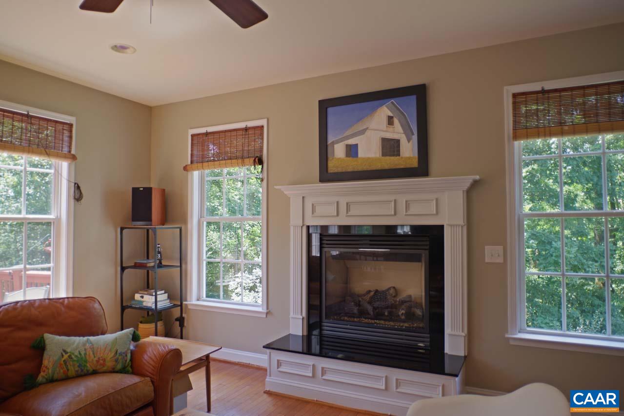 2059 Ridgetop Drive Charlottesville, VA 22903 - Photo 23 of 68 a living room with furniture a window and a fireplace