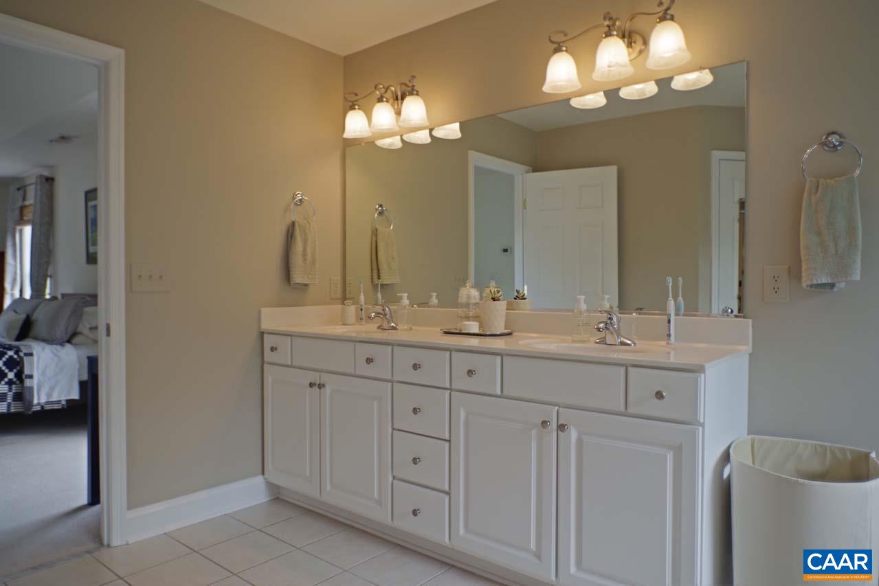 2059 Ridgetop Drive Charlottesville, VA 22903 - Photo 36 of 68 a bathroom with a double vanity sink and a mirror