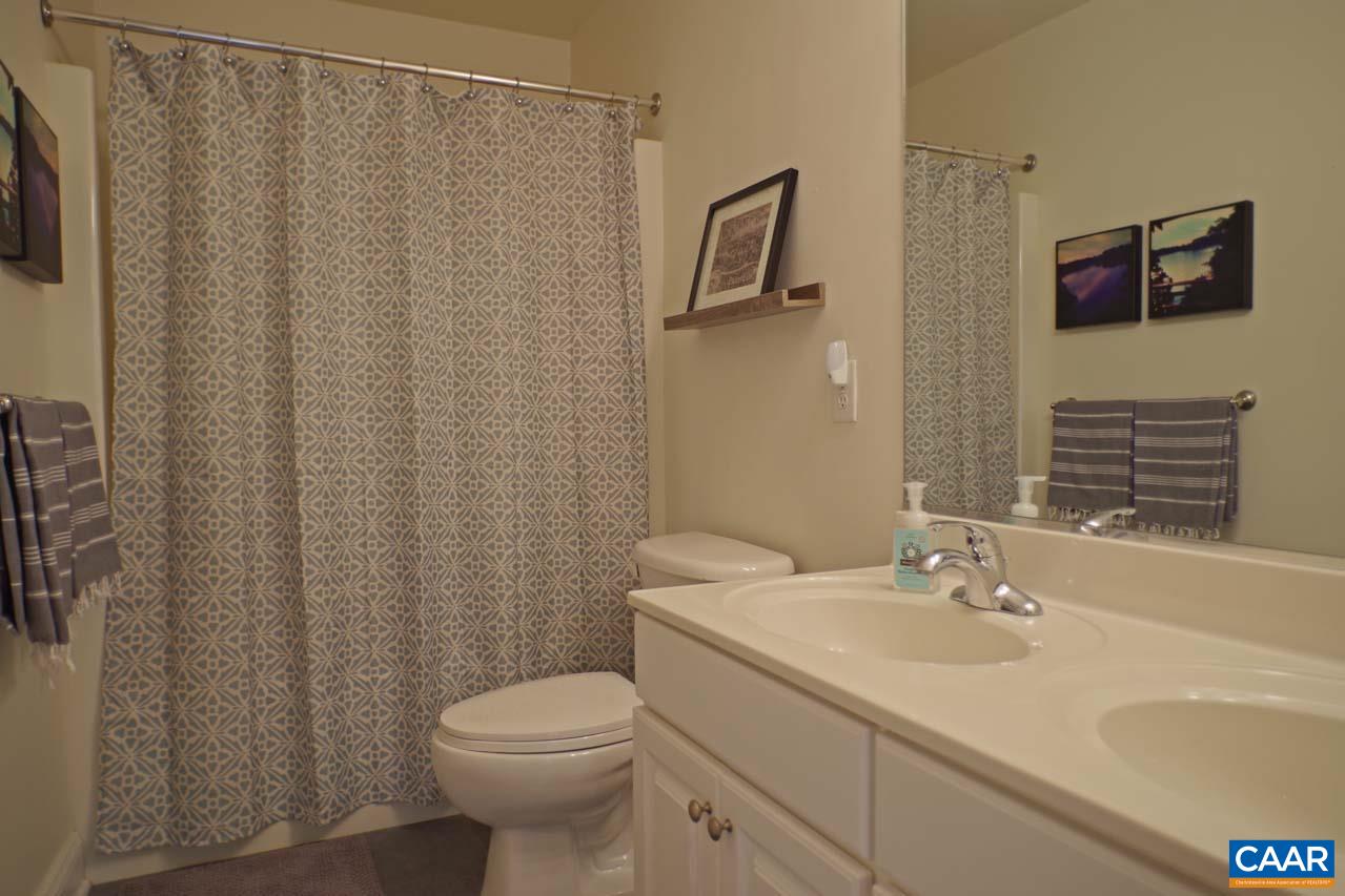 2059 Ridgetop Drive Charlottesville, VA 22903 - Photo 44 of 68 a bathroom with a sink a toilet and shower curtain