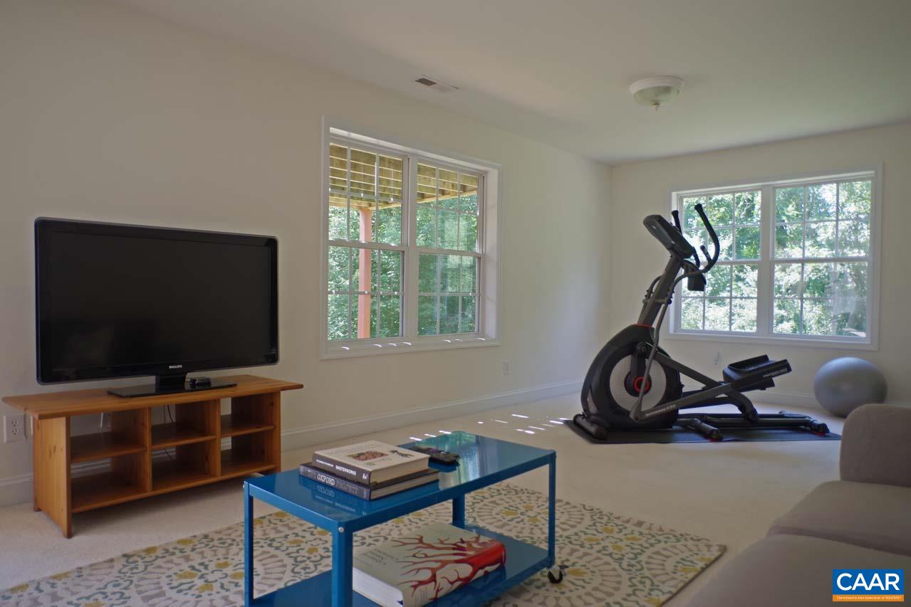2059 Ridgetop Drive Charlottesville, VA 22903 - Photo 57 of 68 a living room with furniture a flat screen tv and a large window